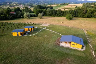 an aerial view of a farm with cabanas in a field at Seosko Domaćinstvo Protic , Prijedor , Veliko Palančište in Velika Palančište