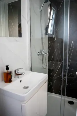 a bathroom with a sink and a shower at Seosko Domaćinstvo Protic , Prijedor , Veliko Palančište in Velika Palančište