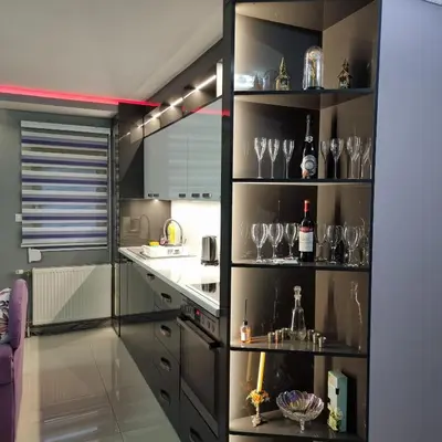 a kitchen with black shelves with wine glasses at Ramonda Smještaj in Tuzla