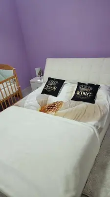 a white bed with two pillows on top of it at Ramonda Smještaj in Tuzla