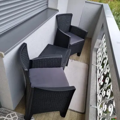 two chairs and a table on a balcony at Ramonda Smještaj in Tuzla