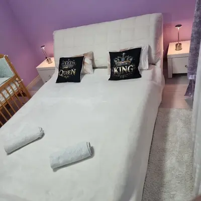 a large white bed with two pillows on it at Ramonda Smještaj in Tuzla