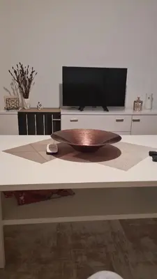 a table with a wooden plate on top of it at Ali app in Travnik
