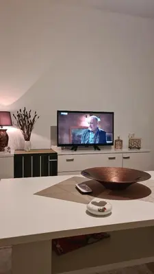 a living room with a television and a table at Ali app in Travnik