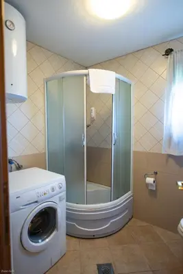 a washing machine and a washer in a bathroom at Hotel & Distillery Monogram in Mišići