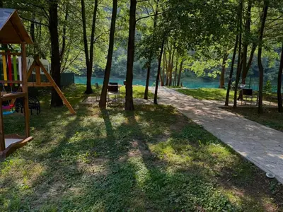 a playground in a park next to the water at UNA Dream in Bihać