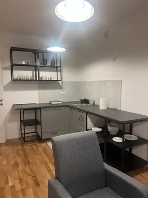a room with a desk and a chair and a table at Apartman Perfectroom in Ivišovo Greblje