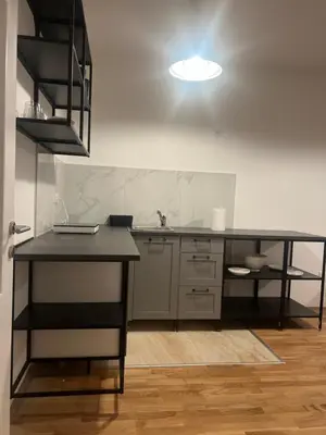 a kitchen with a black counter and a sink at Apartman Perfectroom in Ivišovo Greblje