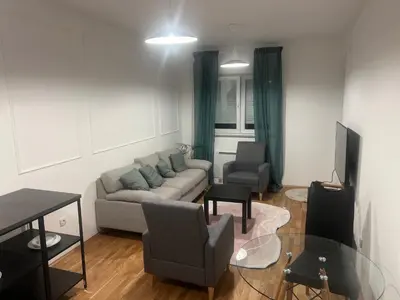 a living room with a couch and a table at Apartman Perfectroom in Ivišovo Greblje
