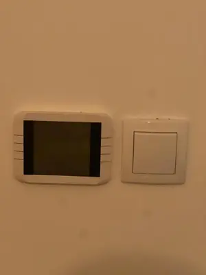 a small television on a wall with a switch at Apartman Perfectroom in Ivišovo Greblje