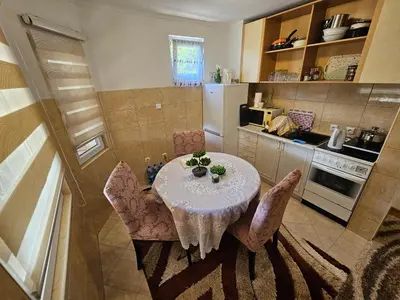a kitchen with a table and chairs in a room at Villa Harmonija