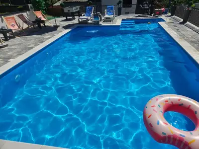 a swimming pool with a life ring in the water at Villa Harmonija