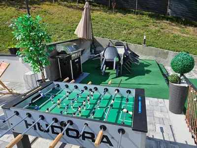 a ping pong game on a table in a backyard at Villa Harmonija
