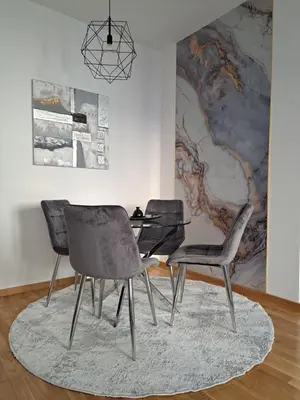 a dining room with two chairs and a glass table at Apartman Luxury kod Kafeterije 5 i Wabi Sabi in Banja Luka