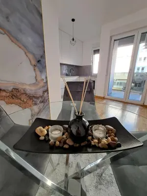 a table with a vase on top of a glass table at Apartman Luxury kod Kafeterije 5 i Wabi Sabi in Banja Luka