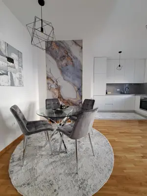 a dining room with a glass table and two chairs at Apartman Luxury kod Kafeterije 5 i Wabi Sabi in Banja Luka