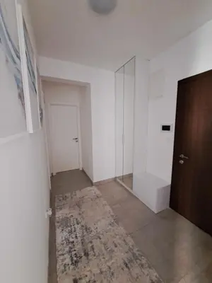 an empty room with a door and a rug at Apartman Luxury kod Kafeterije 5 i Wabi Sabi in Banja Luka