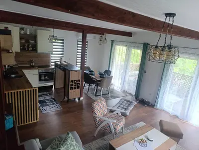 a living room with a kitchen and a dining room at Holiday home Alen in Kulen Vakuf