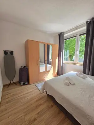 a bedroom with a bed and a large window at Lux Una City in Bihać