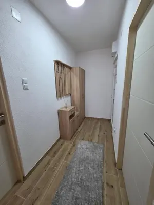 a hallway with white walls and a wooden floor at Lux Una City in Bihać