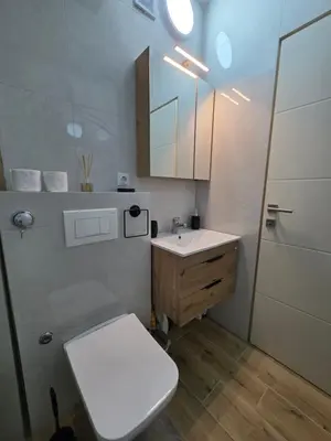 a bathroom with a toilet and a sink and a shower at Lux Una City in Bihać