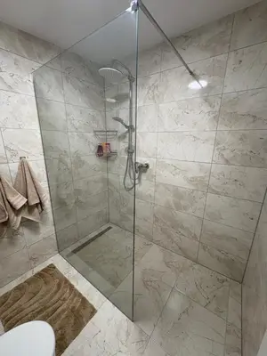a shower with a glass door in a bathroom at Una Hacienda in Bihać