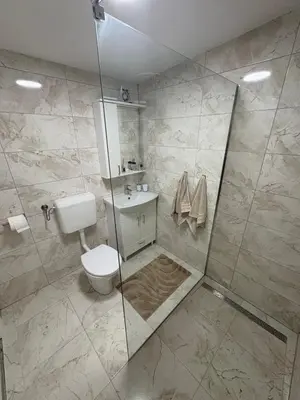 a bathroom with a toilet and a shower at Una Hacienda in Bihać