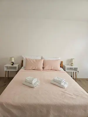 a bed with two white towels on top of it at Jelena in Jajce