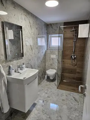 a bathroom with a sink and a shower and a toilet at Jelena in Jajce
