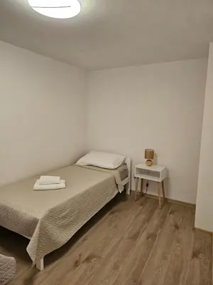 a small bedroom with two beds and a table at Jelena in Jajce