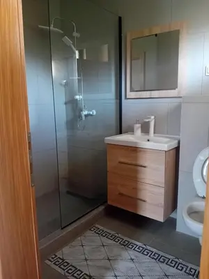 a bathroom with a shower and a sink and a toilet at Vikendica Šapat Sane, Prijedor