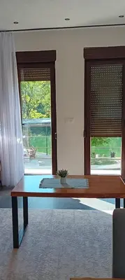 a wooden table in a room with a window at Vikendica Šapat Sane, Prijedor