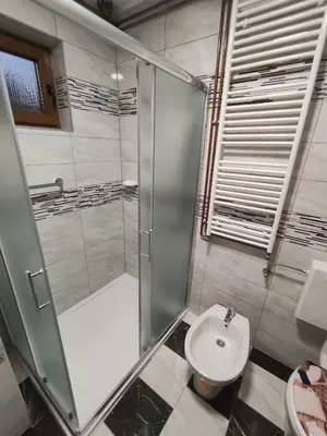 a bathroom with a shower and a toilet and a sink at Apartman Lidija in Bihać
