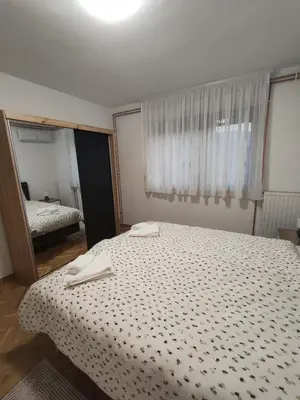 a bedroom with a bed with two towels on it at Apartman Lidija in Bihać