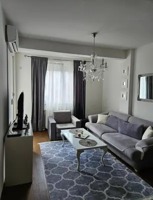 a living room with a couch and a table at Comfort u blizini Klinickog Centra Banja Luka in Lauš