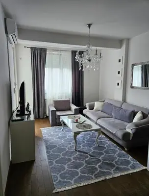 a living room with a couch and a table at Comfort u blizini Klinickog Centra Banja Luka in Lauš
