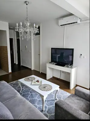 a living room with a couch and a tv at Comfort u blizini Klinickog Centra Banja Luka in Lauš