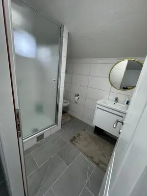 a bathroom with a shower and a sink and a mirror at Apartman Studio EMA in Orašac