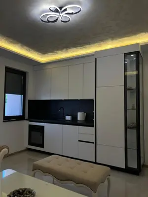 a kitchen with white cabinets and a ceiling at Villa Aurea in Bihać