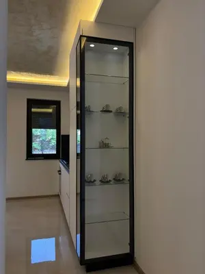 a glass door in a hallway with shoes on shelves at Villa Aurea in Bihać