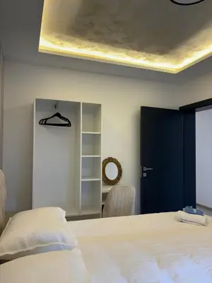 a bedroom with a large bed and a blue door at Villa Aurea in Bihać