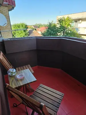 a patio with a table and chairs on a balcony at Apartman Maja in Bosanski Šamac