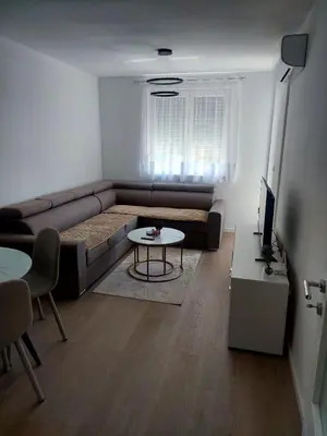 a living room with a couch and a table at Apartman Sofia Doboj in Doboj