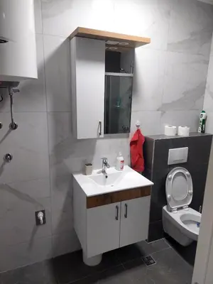 a bathroom with a white sink and a toilet at Apartman Sofia Doboj in Doboj
