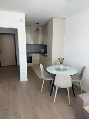 a kitchen and a table and chairs in a room at Apartman Sofia Doboj in Doboj