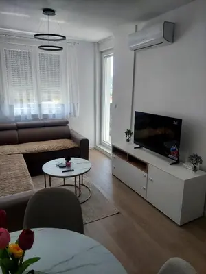 a living room with a couch and a flat screen tv at Apartman Sofia Doboj in Doboj