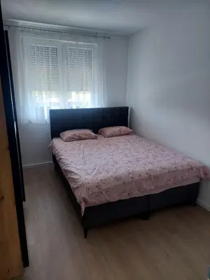 a bedroom with a bed in a room with a window at Apartman Sofia Doboj in Doboj