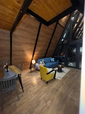 a living room with a blue couch and a table at Villa Šašava in Bosanska Gradiška