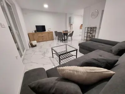 a living room with a couch and a table at Vikendica Dijana Ramsko jezero