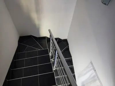 a staircase in a building with a metal railing at Villa Mostanica, Kozarska Dubica